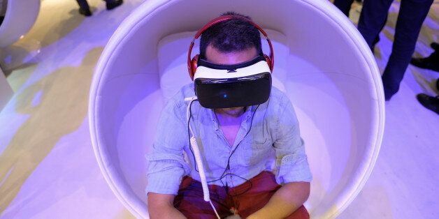 A visitor wears virtual reality glasses Gear VR by Oculus at the IFA Electronics show in Berlin, Germany September 2, 2016. REUTERS/Stefanie Loos