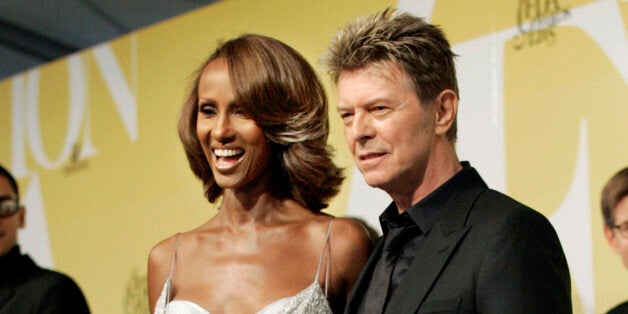 CORRECTS DATE OF DEATH TO SUNDAY, JAN. 10, 2016 - FILE - In this June 6, 2005 file photo, singer David Bowie and his wife Iman pose at the 2005 CFDA Fashion Awards in New York. Bowie, the innovative and iconic singer whose illustrious career lasted five decades, died Sunday, Jan. 10, 2016, after battling cancer for 18 months. He was 69 (AP Photo/Stuart Ramson, File)