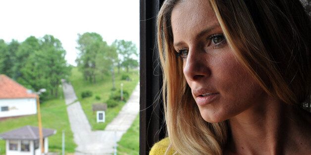 Former Bosnian Miss and Playboy model, Slobodanka Tosic looks out of a window of her flat in her hometown of Han Pijesak on July 12, 2016.Bosnia's appeal court upheld today a prison sentence against Tosic for laying a honey trap for a Bosnian mafia boss and helping a rival try to kill him, prosecutors said. Tosic was jailed for two-and-a-half years for arranging a date with gangster Djordje Zdrale in 2006 and betraying him to his archrival Darko Elez, who then attempted to have him murdered. / AFP / ELVIS BARUKCIC (Photo credit should read ELVIS BARUKCIC/AFP/Getty Images)