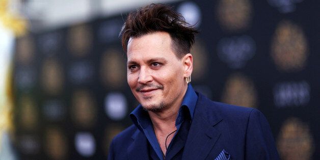 Cast member Johnny Depp poses at the premiere of