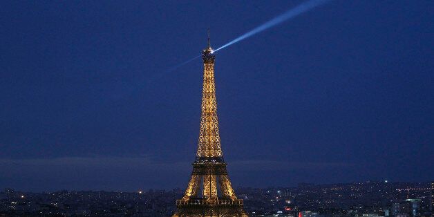 PARIS, FRANCE - DECEMBER 21: The Eiffel Tower by night is seen from the 'Arc de triomphe' on December 21, 2015 in Paris, France. Tourists from around the world will visit the Champs-Elysees, Eiffel tower, department stores, and surrounding neighborhoods to enjoy the magic of the end of year illuminations. (Photo by Chesnot/Getty Images)