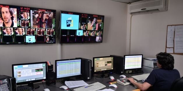 A woman works at the master control room of the private braodcaster Antenna in Athens northern suburb on September 2, 2016. Greece raised 246 million euros ($274 million) on September 2, 2016 by auctioning four private TV licenses in a marathon bid dominated by shipowners including the boss of the country's top football club. Skai and Antenna, also owned by shipowning families, are the sole surviving members of the previous Greek TV cast. The government has said stations that broadcast nationwide without a license will be blocked three months after the auction is concluded. / AFP / LOUISA GOULIAMAKI (Photo credit should read LOUISA GOULIAMAKI/AFP/Getty Images)