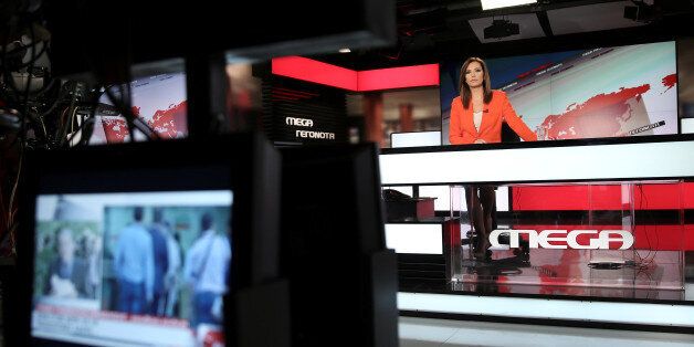 News anchor Maria Sarafoglou is seen during a news broadcast at a studio of Greek private channel MEGA in Athens, Greece, August 30, 2016. REUTERS/Alkis Konstantinidis