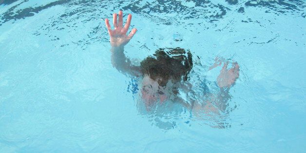 'Young boy, sinking into the water (no actual children hurt during the making of this photo).'