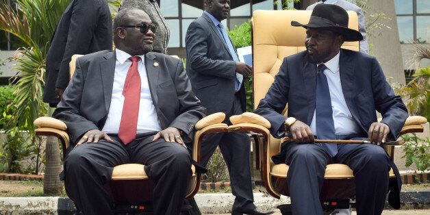 FILE - In this Friday, April 29, 2016 file photo, South Sudan's then First Vice President Riek Machar, left, looks across at President Salva Kiir, as the two sit to be photographed following the first meeting of a new transitional coalition government, in the capital Juba, South Sudan. According to reports from victims which have come to light Monday Aug. 15, 2016, South Sudanese troops, fresh from winning a battle against opposition forces in the capital, Juba, on July 11, 2016, went on a nearly four-hour rampage through a residential compound popular with foreigners, and the U.N. peacekeeping force stationed nearby are accused of refusing to respond to desperate calls for help. (AP Photo/Jason Patinkin, File)
