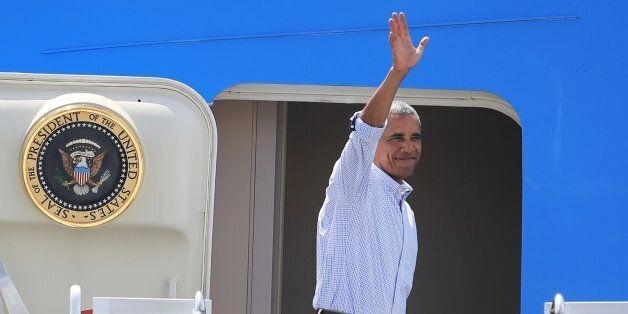 U.S. President Barack Obama waves to spectators as he departs from Joint Base Pearl Harbor-Hickam, Friday, Sept. 2, 2016, in Honolulu. Obama is headed Friday for Hangzhou, China, where he will meet on Saturday with Xi ahead of a summit of the Group of 20. (AP Photo/Marco Garcia)