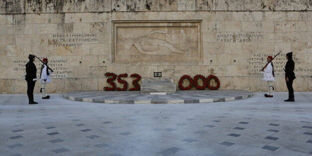 SYNTAGMA SQUARE, ATHENS, ATTICA, GREECE - 2015/05/19: Four Evzones (Greek Presidential Guard), two dressed in the black traditional uniforms of Pontic soldiers stand to attention at the Tomb of the Unknown Soldier, after the wreaths that show the numbers of Greeks killed in the genocide. Greeks from the Pontus region (Black Sea) hold a commemoration ceremony for the anniversary of the Pontic genocide by the Ottoman Empire. The Pontic genocide is the ethnic cleansing of the Christian Greek population from the Pontus area in Turkey during World War I and its aftermath. (Photo by Michael Debets/Pacific Press/LightRocket via Getty Images)