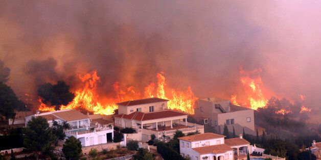 A wildfire burns nearby Benitachel village, eastern Spain, Monday, Sept. 5, 2016. Spanish firefighters are still working to bring under control a forest blaze near Valencia that forced the evacuation of around 1,000 people. Authorities said more than 200 firefighters with 65 vehicles were deployed Monday to the wildfire some 350 kilometers (220 miles) southeast of Madrid. (AP Photo/Alberto Saiz)