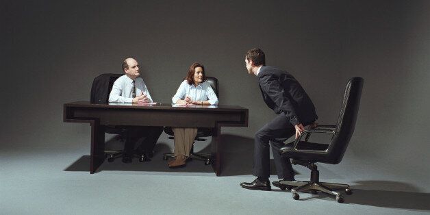 Young businessman being interviewed by two people