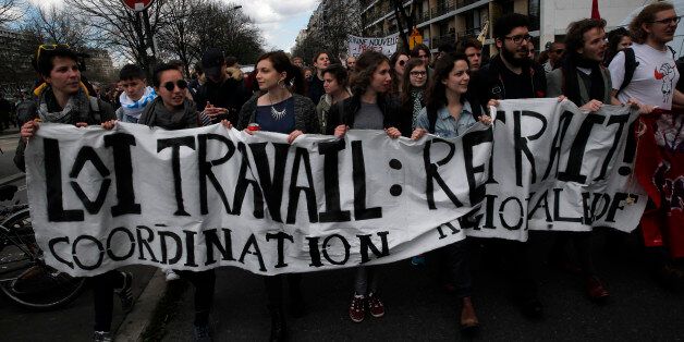 Youth march during a protest against proposed changes to France's work week and layoff practices, in Paris, Tuesday, April 5, 2016. Socialist President Francois Hollande's government, desperately trying to lower unemployment, says the bill will encourage hiring, especially of young people. But unions and students say it erodes hard-fought worker protections. The banner reads: