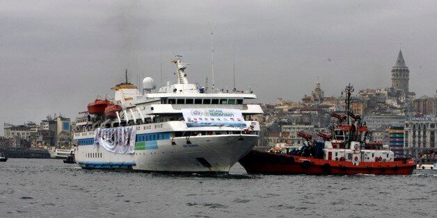 With historical Galata Tower in the background, the Mavi Marmara ship, the lead boat of a flotilla headed to the Gaza Strip which was stormed by Israeli naval commandos in a predawn confrontation in the Mediterranean May 31, 2010, returns, inn Istanbul, Turkey, Sunday, Dec. 26, 2010. Israeli naval commandos stormed a flotilla of ships carrying aid and hundreds of pro-Palestinian activists to the blockaded Gaza Strip on May 31, killing nine passengers in a botched raid that provoked international outrage and a diplomatic crisis. The posters of nine people killed on the ship seen on the side.(AP Photo/Burhan Ozbilici)