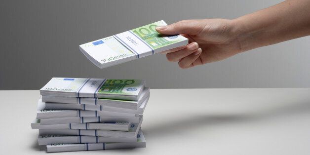 Hand Holding Stack of Notes
