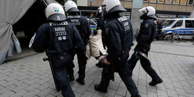 German riot police evacuate a protester during a protest for Turkish President Tayyip Erdogan in Cologne, Germany July 31, 2016. REUTERS/Vincent Kessler