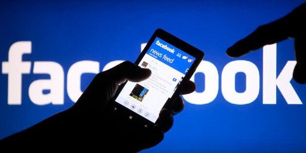 A smartphone user shows the Facebook application on his phone in the central Bosnian town of Zenica, in this photo illustration, May 2, 2013. Facebook Inc's mobile advertising revenue growth gained momentum in the first three months of the year as the social network sold more ads to users on smartphones and tablets, partially offsetting higher spending which weighed on profits. REUTERS/Dado Ruvic (BOSNIA AND HERZEGOVINA - Tags: SOCIETY SCIENCE TECHNOLOGY BUSINESS)