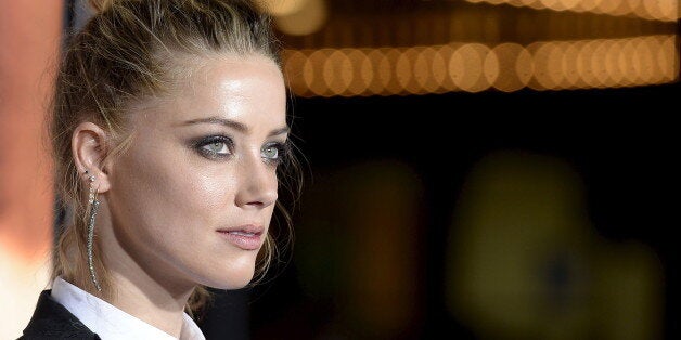 Cast member Amber Heard poses during the premiere of the film