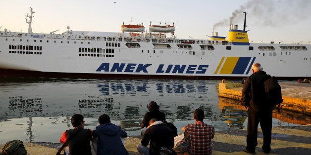 Syrian refugees rest after arriving in the port of Piraeus near Athens June 14, 2015. Over 1,800 predominantly Syrian refugees and other immigrants who crossed the sea from the Turkish coast to the Greek island of Lesvos were ferried to Athens after the Greek authorities supplied them with temporary documents. An average of 600 migrants were arriving in Greece by sea each day, many of them fleeing poverty and conflicts in Syria, Iraq and Libya, at a time when the Athens government is facing its