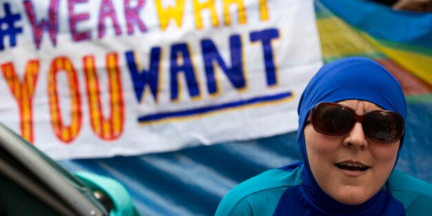 A woman wearing a 'Burkini' joins a protest outside the French Embassy in London on August 25, 2016, during a 'Wear what you want beach party' to demonstrate against the ban on Burkinis on French beaches and to show solidarity with Muslim women.French Interior Minister Bernard Cazeneuve warned Wednesday against stigmatising Muslims, as a furore over the banning of burkinis grew with the emergence of pictures showing police surrounding a veiled woman on a beach. Dozens of French towns and villages, mostly on the Cote d'Azur, have banned beachwear that 'conspicuously' shows a person's religion -- a measure aimed at the full-body Islamic swimsuit but which has also been used against women wearing long clothes and a headscarf. / AFP / JUSTIN TALLIS (Photo credit should read JUSTIN TALLIS/AFP/Getty Images)