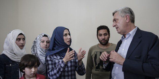 ATHENS, GREECE - AUGUST 24: United Nations High Commissioner for Refugees Filippo Grandi (R) talks with people during his visit a refugees' house, which is supplied for refugees by the United Nations in Athens, Greece on August 24, 2016. (Photo by Ayhan Mehmet/Anadolu Agency/Getty Images)