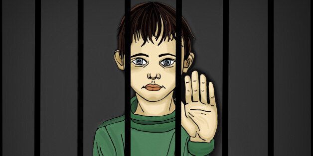 The child in prison. Children of criminals. Behind bars. Juvenile criminals. Angry and unhappy boy showing hand sign enough. Against violence. Stop the violence. Portrait on the dark background. Pop Art illustration.