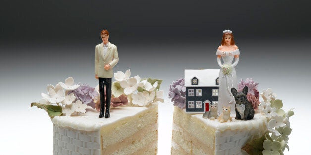 Bride and groom figurines standing on two separated slices of wedding cake