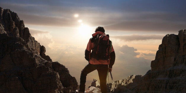 Lone climber on a mountain at sunrise