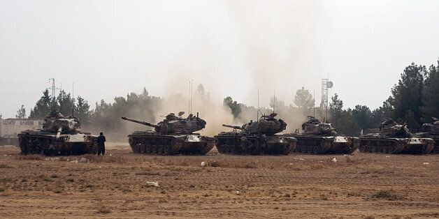 Turkish army tanks stationed near the Syrian border, in Karkamis, Turkey, Thursday, Aug. 25, 2016. Turkish President Recep Tayyip Erdogan late Wednesday said that Syrian opposition forces aided by Ankara have taken back the border town of Jarablus from the Islamic State group. (AP Photo)