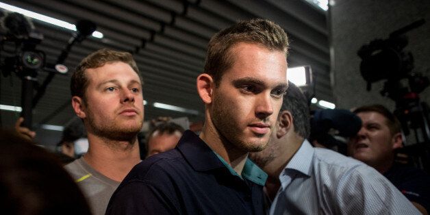 RIO DE JANEIRO, BRAZIL - AUGUST 17: U.S Olympic swimmers Gunnar Bentz and Jack Conger leave the police headquarters at International departures of Rio de Janiero's Galeo International airport on August 18, 2016 in Rio de Janiero, Brazil. The swimmers were removed from their flight departing for the United States by Brazilian authorities in relation to an armed robbery incident earlier in the week which included fellow U.S swimmers Ryan Lochte and James Feign. (Photo by Chris McGrath/Getty Images)