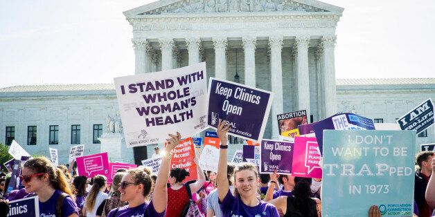 WASHINGTON, DC - JUNE 27: Pro-choice and pro-life activists demonstrate on the steps of the United States Supreme Court on June 27, 2016 in Washington, DC. In a 5-3 decision, the U.S. Supreme Court struck down one of the nation's toughest restrictions on abortion, a Texas law that women's groups said would have forced more than three-quarters of the state's clinics to close. (Photo by Pete Marovich/Getty Images)