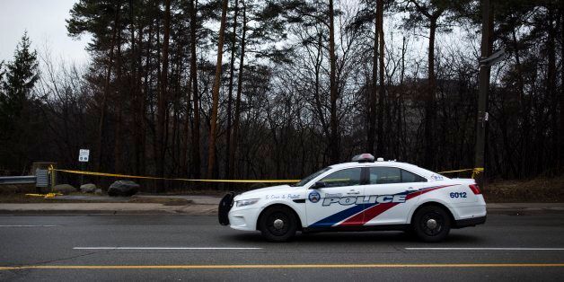TORONTO, ON - March 14 - A police car drives past police tape around the park near Don River Trail at Sheppard Avenue and Leslie Street, where the fatal police shooting of 21-year-old man occurred. (Melissa Renwick/Toronto Star via Getty Images)