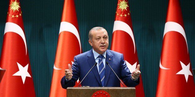 Turkish President Recep Tayyip Erdogan delivers a speech at the Presidential Palace in Ankara, Thursday, Aug. 18, 2016. Erdogan has called on the United States not to delay the extradition of U.S.-based Muslim cleric Fethullah Gulen, whom Turkey accuses of orchestrating last month's violent coup attempt. (Presidential Press Service via AP)