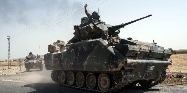 Turkish troops head to the Syrian border, in Karkamis, Turkey, Saturday, Aug. 27, 2016. Turkey on Wednesday sent tanks across the border to help Syrian rebels retake the key Islamic State-held town of Jarablus and to contain the expansion of Syria's Kurds in an area bordering Turkey. (AP Photo/Halit Onur Sandal)