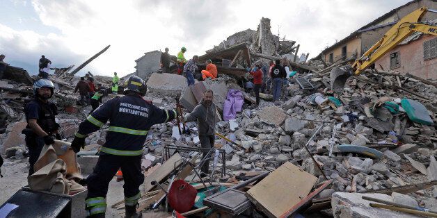 Rescuers search for survivors through the rubble of collapsed buildings following an earthquake, in Amatrice, Italy, Wednesday, Aug. 24, 2016. The magnitude 6 quake struck at 3:36 a.m. (0136 GMT) and was felt across a broad swath of central Italy, including Rome where residents of the capital felt a long swaying followed by aftershocks. (AP Photo/Alessandra Tarantino)