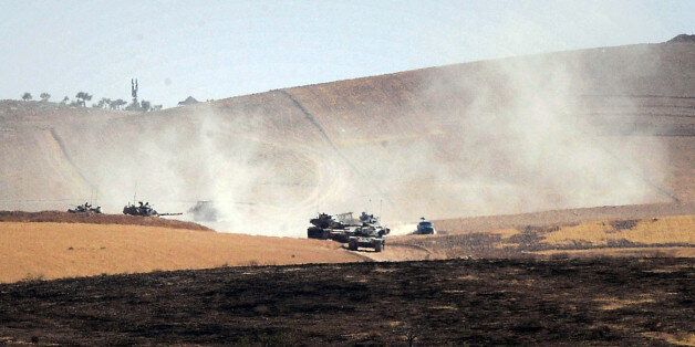 Turkish military move inside Syria near the Turkish border town of Karkamis, Turkey, Friday, Aug. 26, 2016. Turkey's state-run Anadolu news agency said late Thursday Turkish artillery have shelled a group of Syrian Kurdish militia fighters in he north of the town of Mambij after they allegedly ignored warnings to retreat. (Ismail Coskun, IHA via AP)