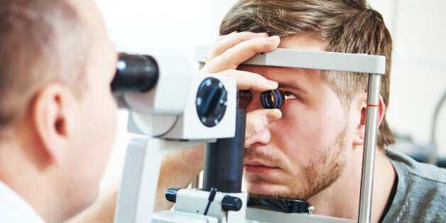 Ophthalmology concept. Male patient under eye vision examination in eyesight ophthalmological correction clinic