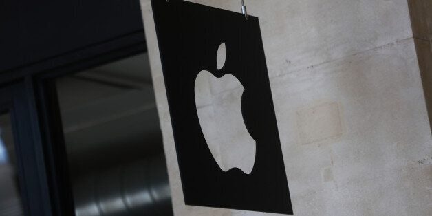 A logo sits on a sign hanging outside Apple Inc.'s Covent Garden store in London, U.K., on Tuesday, Aug. 30, 2016. Apple Inc. was ordered to repay a record 13 billion euros ($14.5 billion) plus interest after the European Commission said Ireland illegally slashed the iPhone maker's tax bill. Photographer: Simon Dawson/Bloomberg via Getty Images