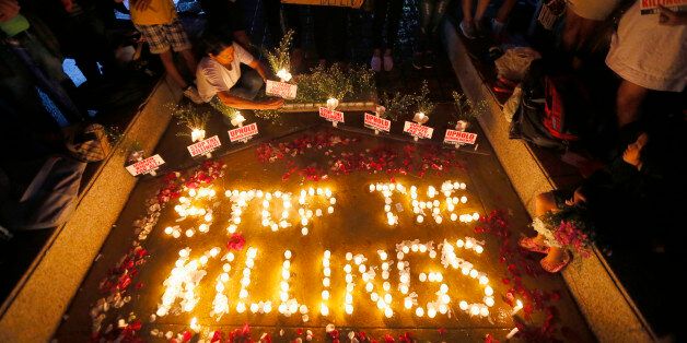 Human rights activists light candles for the victims of extra-judicial killings around the country in the wake of
