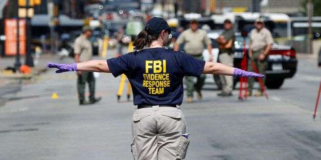 A member of the FBI Evidence Response Team stands on Elm Street outside El Centro College in Dallas, Texas, U.S., July 8, 2016. REUTERS/Shannon Stapleton