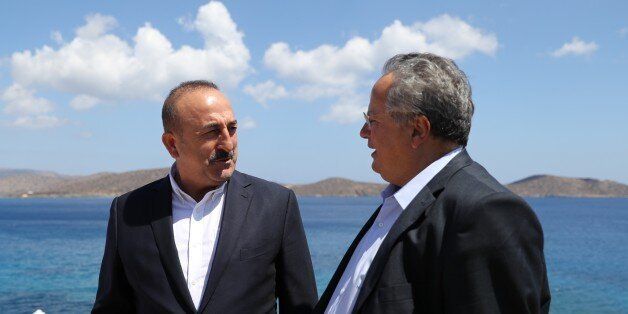 CRETE, GREECE - AUGUST 28: Turkish Foreign Minister Mevlut Cavusoglu (L) speaks with his Greek counterpart Nikos Kotzias (R) during his unofficial visit in Crete, Greece on August 28, 2016. (Photo by Fatih Aktas/Anadolu Agency/Getty Images)