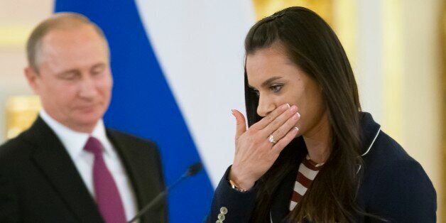 Russia's pole vaulter and Olympic champion Yelena Isinbayeva gestures after speaking at the Kremlin, in Moscow, Russia, Wednesday, July 27, 2016 during a reception for the Russia's Olympics team. At least 105 athletes from the 387-strong Russian Olympic team announced last week have been barred from the Rio Games in connection with the country's doping scandal. (AP Photo/Alexander Zemlianichenko)