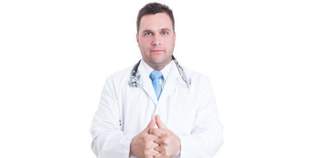 Male medic or doctor cracking his knuckles like feeling ready isolated on white background with advertising area