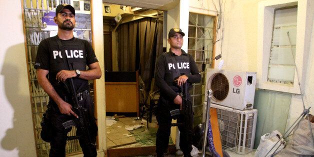 Pakistani police commandos stand guard in local media office, after an attack by supporters of Pakistan's Muttahida Qaumi Movement in Karachi, Pakistan, Monday, Aug. 22, 2016. Pakistani officials say protesters have attacked TV stations and clashed with police in the southern city of Karachi, leaving one person dead and eight others wounded, including three media workers. (AP Photo/Fareed Khan)