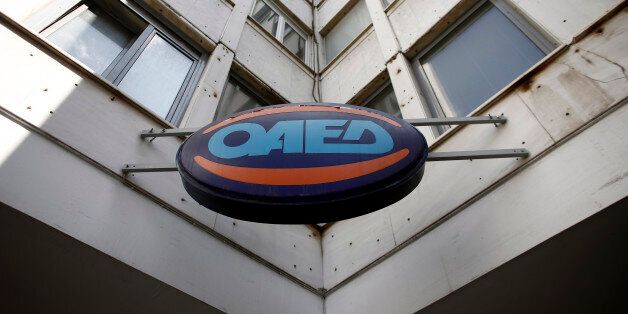 A logo sits on display outside an OAED employment center in Athens, Greece, on Friday, May 8, 2015. Prime Minister Alexis Tsipras said there are no more technical reasons to withhold aid from Greece with his officials locked in talks in a bid to break a 100-day impasse with the country's creditors. Photographer: Kostas Tsironis/Bloomberg via Getty Images
