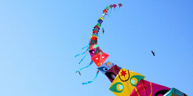 Row of kites in sky at International Kite Festival, Ahmedabad.
