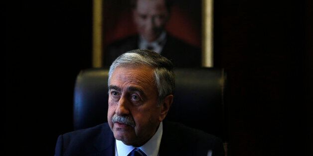 Turkish Cypriot leader Mustafa Akinci is seen at his office in front of the portrait of the Turkish Republic founder Kemal Ataturk, during an interview for the Associated Press in the Turkish breakaway north part of the divided capital Nicosia in this ethnically Mediterranean island of Cyprus, Monday, April 4, 2016. The leader of the breakaway Turkish Cypriots says the ethnically divided islandâs potential wealth from newly found offshore gas deposits could partly pay for a costly reunification deal. (AP Photo/Petros Karadjias)