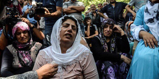 TOPSHOT - Women cry during a funeral for a victim of last night's attack on a wedding party that left 50 dead in Gaziantep in southeastern Turkey near the Syrian border on August 21, 2016. At least 50 people were killed when a suspected suicide bomber linked to Islamic State jihadists attacked a wedding thronged with guests, officials said on August 21. Turkish President Recep Tayyip Erdogan said the IS extremist group was the 'likely perpetrator' of the bomb attack, the deadliest in 2016, in Gaziantep late Saturday that targeted a celebration attended by many Kurds. / AFP / ILYAS AKENGIN (Photo credit should read ILYAS AKENGIN/AFP/Getty Images)