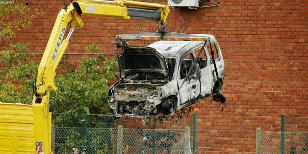 This picture taken on August 29, 2016, shows the burnt car used to ram raid the National Institute for Criminalistics and Criminology (INCC-NICC) overnight in Neder-Over-Heembeek. An explosion 'of criminal origin' at Belgium's national criminology institute in Brussels early on August 29, 2016, caused a fire and major damage but no casualties, officials said. Belgian media said the blast was caused by a car which rammed the building. It comes as Belgium remains on high alert following the devast