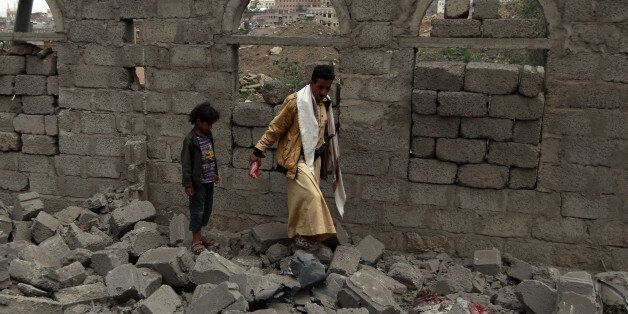 TOPSHOT - Yemenis walk amidst the rubble of a house in Yemen's Huthi rebel-held capital Sanaa on August 11, 2016, after it was reportedly hit by a Saudi-led coalition air strike.Saudi-led coalition jets pounded Shiite rebel positions in and around the Yemeni capital for the third consecutive day as a Saudi woman was killed by shelling from Yemen. / AFP / MOHAMMED HUWAIS (Photo credit should read MOHAMMED HUWAIS/AFP/Getty Images)