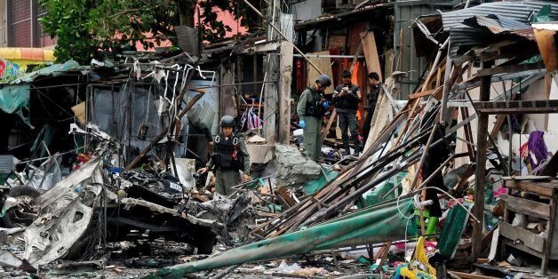 TOPSHOT - Members of a Thai bomb squad inspect the site of a car bomb blast triggered by suspected separatist militants in the Sungai Kolok district of Thailand's restive southern province of Narathiwat on June 26, 2016.More than 6,500 people have been killed -- the majority civilians -- since 2004 in clashes between militants and security forces from Thailand's Buddhist-majority state. / AFP / MADAREE TOHLALA (Photo credit should read MADAREE TOHLALA/AFP/Getty Images)