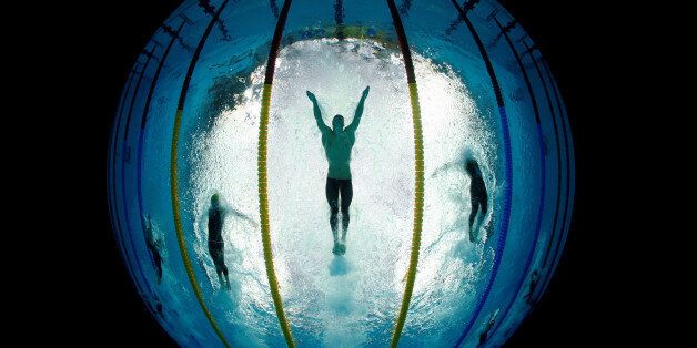 Michael Phelps (C) of the U.S. swims the butterfly stroke during his team's victory in the men's 4x100 meters medley relay at the National Aquatics Center during the Beijing 2008 Olympics in China August 17, 2008. Wolfgang Rattay: