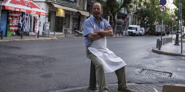 A street vendor waits for customers during early morning in Athens, Greece, July 4, 2015. If a 'No' in Sunday's referendum eventually takes Greece out of Europe's single currency, any